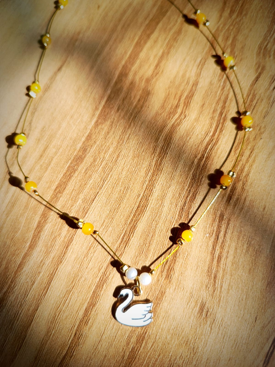 Invisible pendant with yellow bead and swan charm