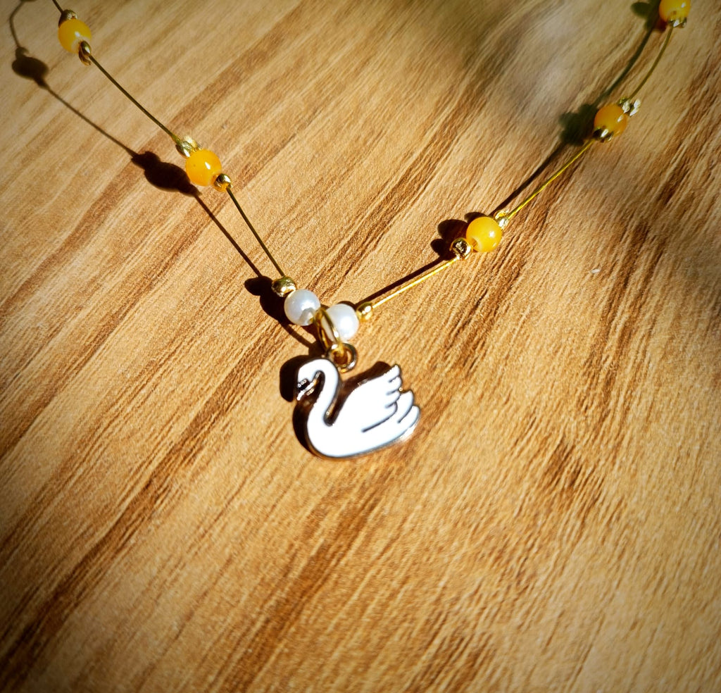 Invisible pendant with yellow bead and swan charm