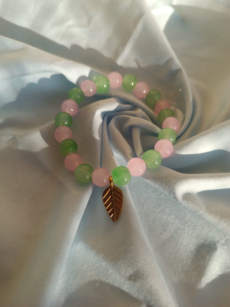 Pink and Green glass beaded bracelet with leaf cham